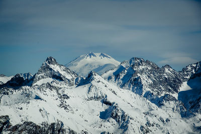 Scenic view of snowcapped mountains against sky