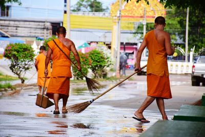 Rear view of people walking on water