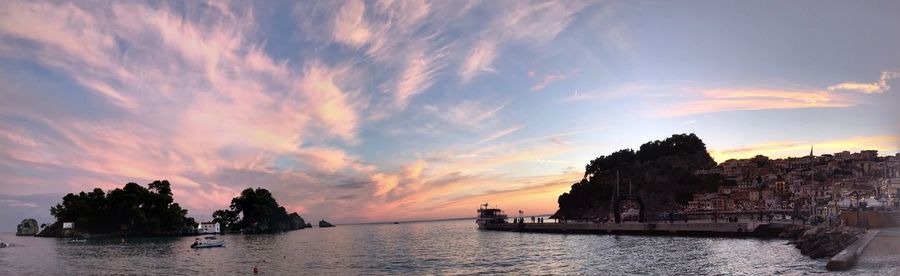 Panoramic view of bay against sky at sunset