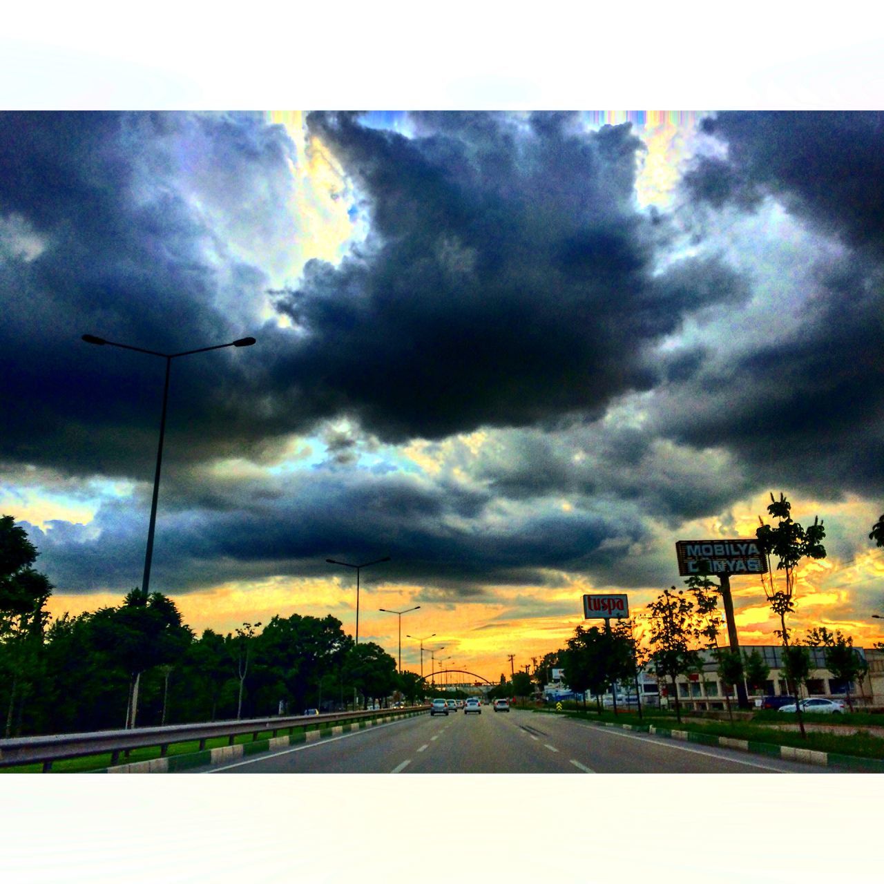 sky, cloud - sky, cloudy, the way forward, weather, overcast, street light, road, transportation, tree, cloud, diminishing perspective, storm cloud, built structure, dramatic sky, nature, sunset, vanishing point, street, architecture