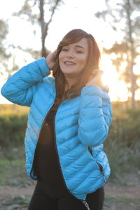 Portrait of smiling young woman standing outdoors