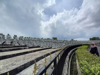 People walking on bridge against sky