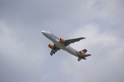 Low angle view of airplane flying against sky