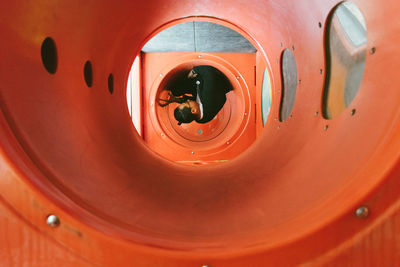 Young man sitting in pipe