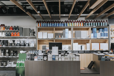 Interior of electronics store with various appliances arranged on shelves for sale