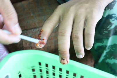 High angle view of person hand holding cigarette