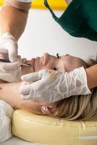 Midsection of doctor examining patient at clinic