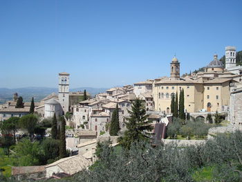 Buildings against clear blue sky