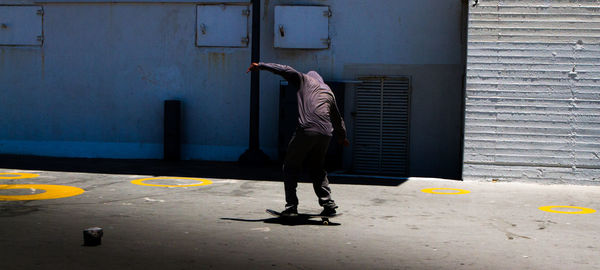 Full length of man skateboarding on skateboard