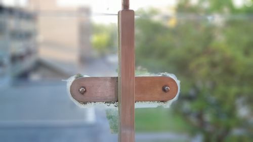 Close-up of rusty metal fence against blurred background