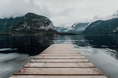 Pier over lake against sky