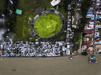 High angle view of crowd on field against buildings in city