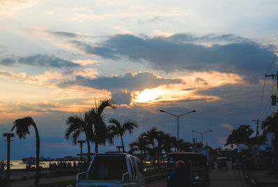 View of road against cloudy sky at sunset