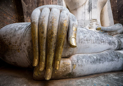 Close-up of buddha statue on wood