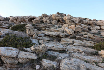 Rock formations on landscape against clear sky