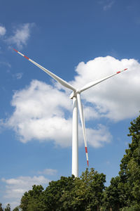 Low angle view of wind turbine against sky