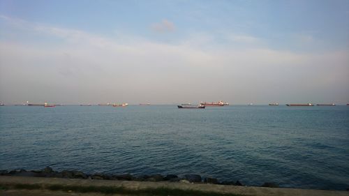 Boat sailing in sea against sky