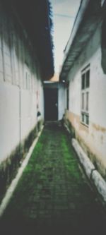 Empty alley amidst buildings in city