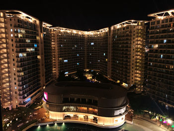 High angle view of illuminated buildings in city at night