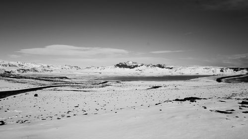 Scenic view of snow covered land against sky