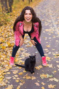 Portrait of smiling woman with autumn leaves