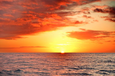 Scenic view of sea against romantic sky at sunset