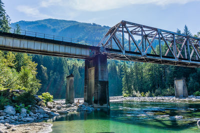 A train trestle spans the skykomish river in washington state.