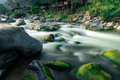 Scenic view of river flowing through rocks