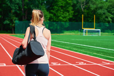 Woman going on fitness training with sport bag
