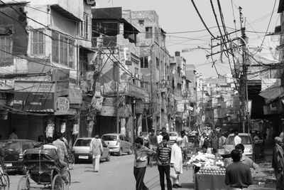 People on street amidst buildings in city