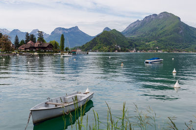 White boat on the lake of annecy in the french alps