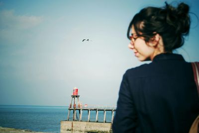 Rear view of woman against sky