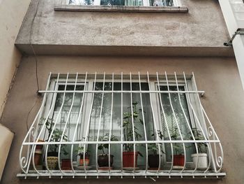 Low angle view of cage on window of building