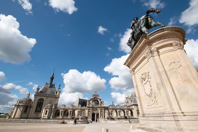 Low angle view of statue against cloudy sky