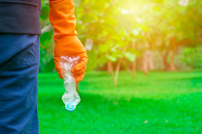 Midsection of man holding orange plant