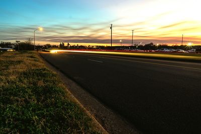 Road on field at sunset