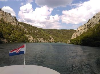 Scenic view of river amidst mountains against sky