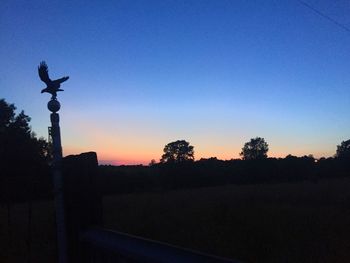 Silhouette of trees against clear sky