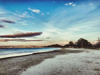 View of beach against cloudy sky