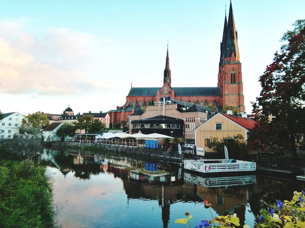 built structure, architecture, building exterior, water, reflection, sky, place of worship, building, religion, waterfront, belief, spirituality, nature, day, nautical vessel, city, tower, no people, outdoors, canal, spire