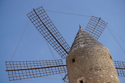 Low angle view of traditional windmill against clear sky