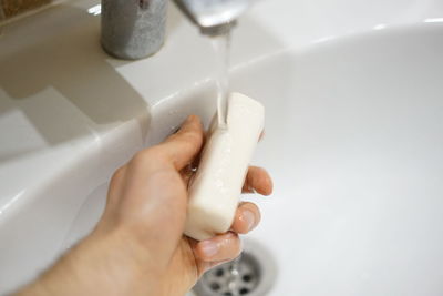 Close-up of woman hand in bathroom