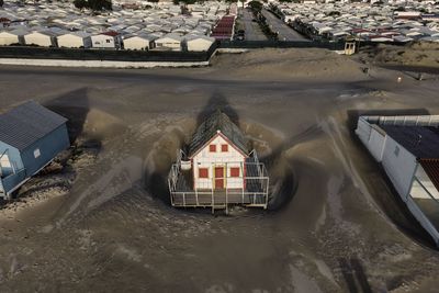 High angle view of canal amidst buildings in city