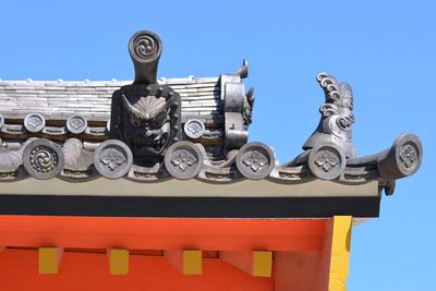 Low angle view of sculpture against blue sky