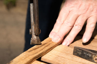 Close-up of cropped hand of man working in workshop