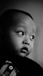 Close-up of cute baby boy looking away