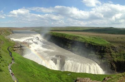 Scenic view of waterfall against sky