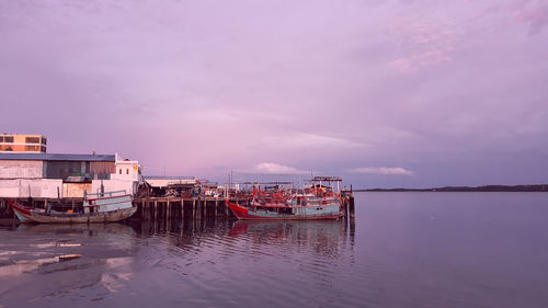 Fishing boat in sea against sky