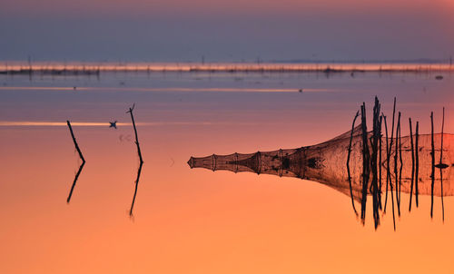 Scenic view of lake against sky during sunset