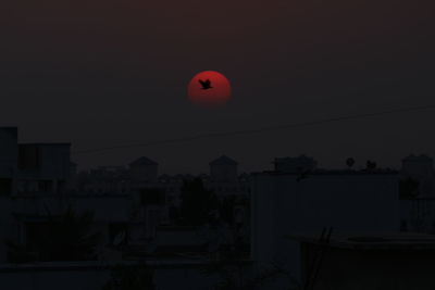 Silhouette of buildings against sky at sunset